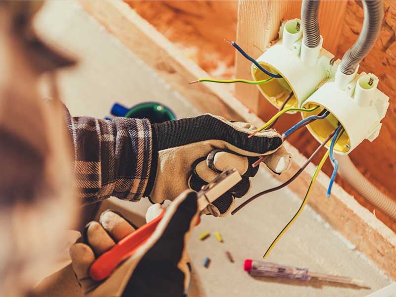 Electrician working on wall-plug wires