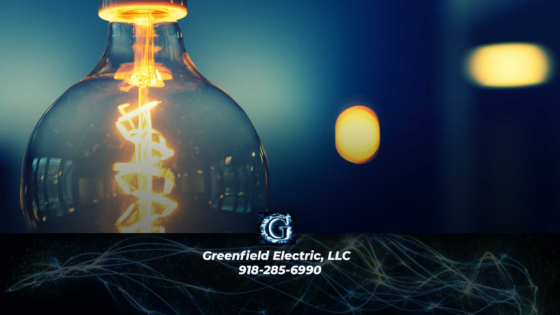 Antique light bulb background with Greenfield Electric, LLC logo