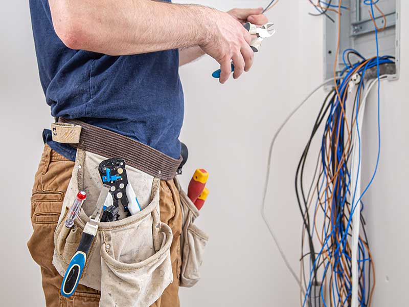 Electrician installing wall plug